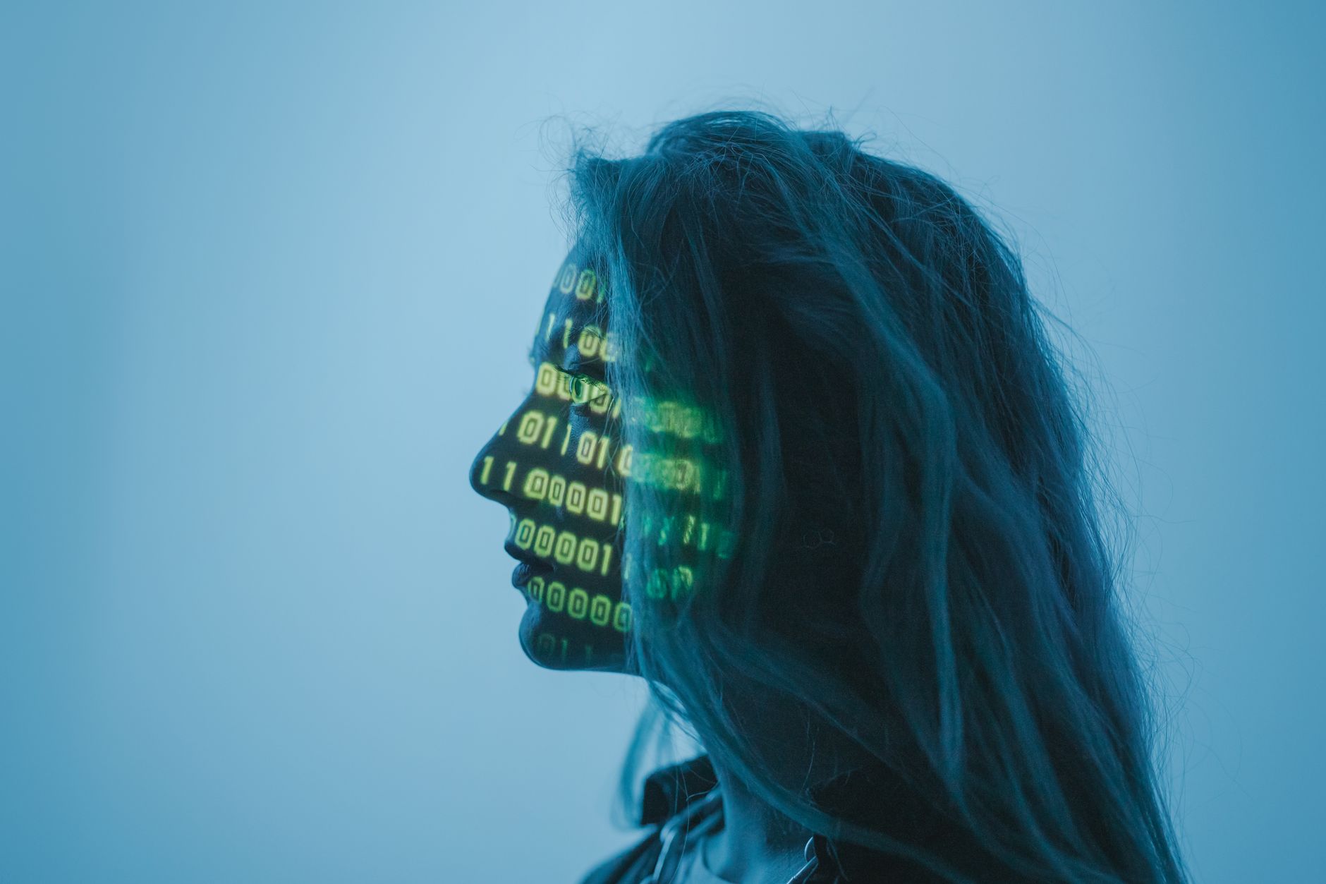 Profile with binary digits projected across a face