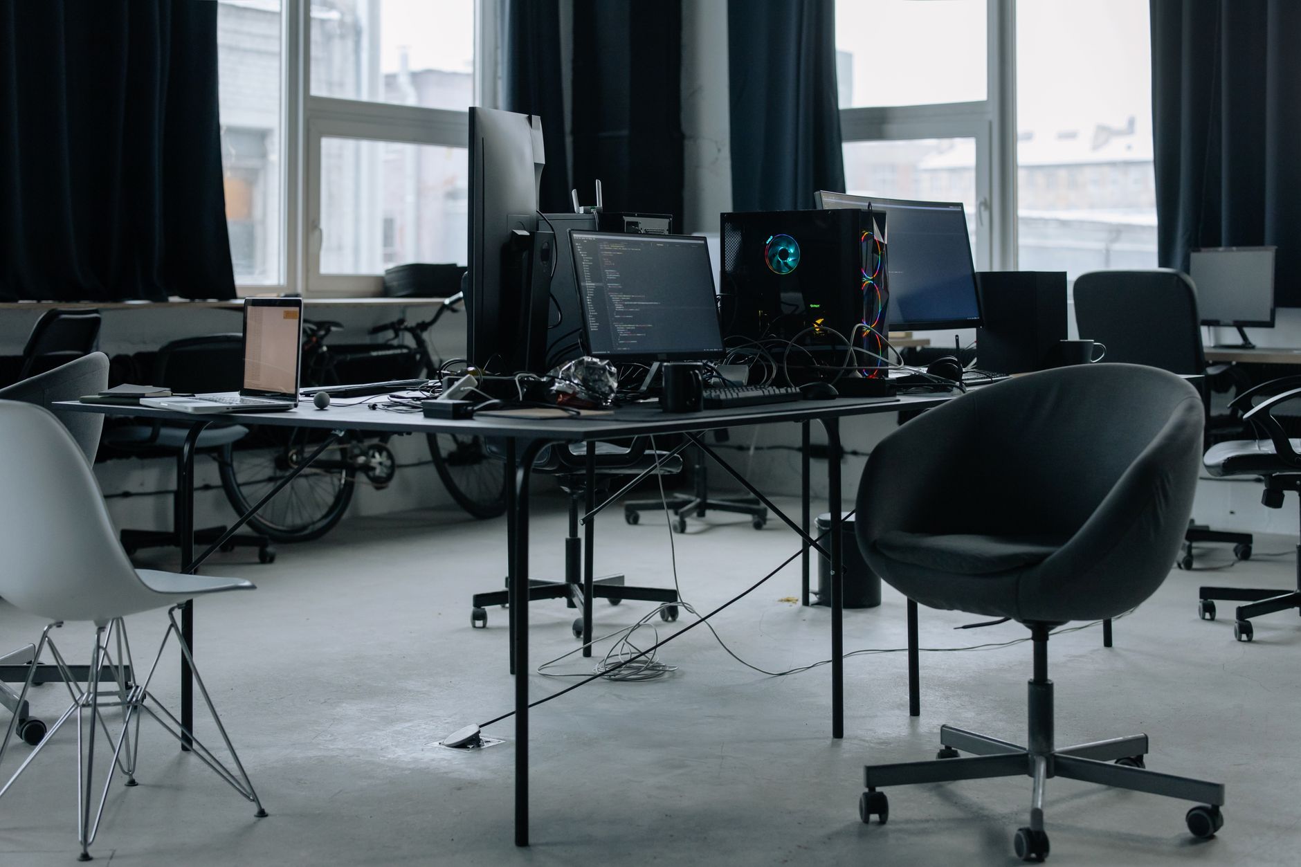 Desk with monitors and code beside a studio window